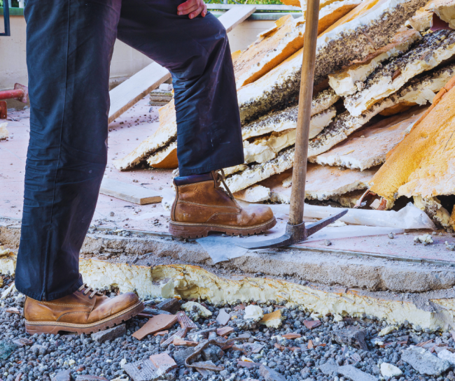 Man wearing work boots at fire debris